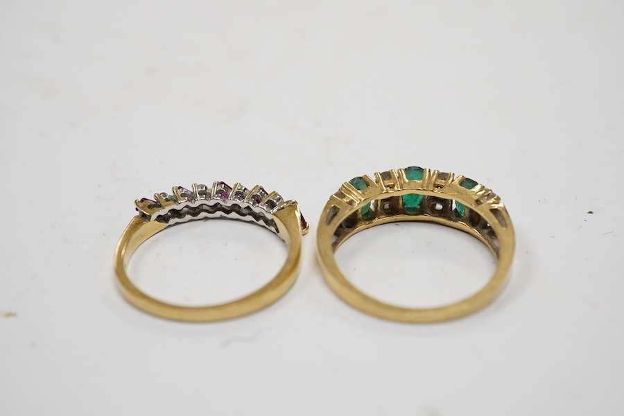 A modern 18ct gold, ruby and diamond set half hoop ring, size M and a yellow metal emerald and diamond set half hoop ring, size L/M, gross weight 6 grams. Condition - poor to fair